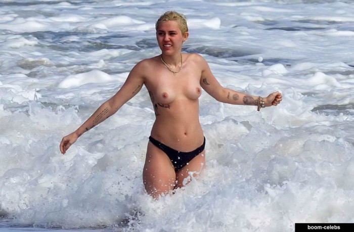 Miley Cyrus topless on the beach